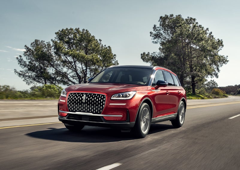 A 2023 Lincoln Corsair® SUV is shown being driven on a country road. | Rydell Lincoln in Independence IA