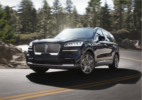 A Lincoln Aviator® SUV is being driven on a winding mountain road | Rydell Lincoln in Independence IA