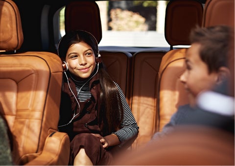 Two young people are comfortably seated in the second and third rows of a Lincoln Aviator® SUV | Rydell Lincoln in Independence IA