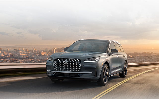 A Lincoln Corsair® Grand Touring model is shown being driven along a scenic roadway.