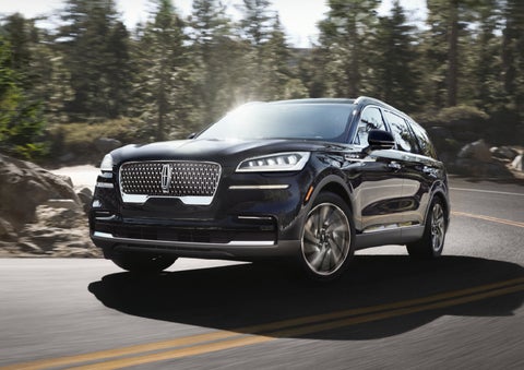 A Lincoln Aviator® SUV is being driven on a winding mountain road | Rydell Lincoln in Independence IA