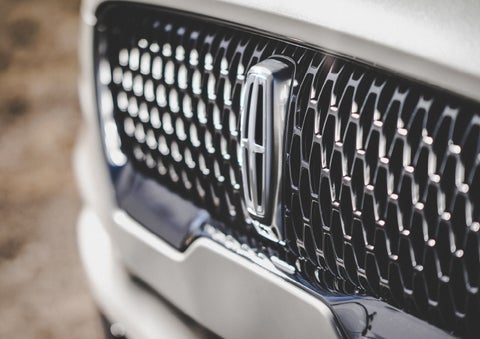 The grille of the 2024 Lincoln Aviator® Reserve model with an eye-catching repeated field of Lincoln Star logo shapes | Rydell Lincoln in Independence IA