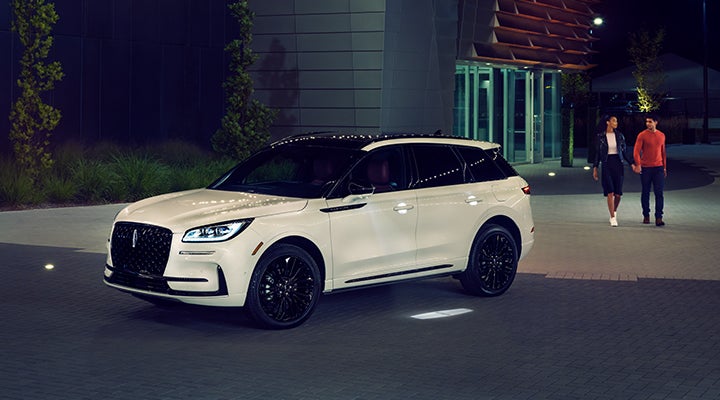 Two people approach a 2024 Lincoln Corsair® SUV featuring the available Jet Appearance Package. | Rydell Lincoln in Independence IA