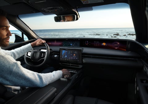 A driver of a parked 2024 Lincoln Nautilus® SUV takes a relaxing moment at a seaside overlook while inside his Nautilus. | Rydell Lincoln in Independence IA