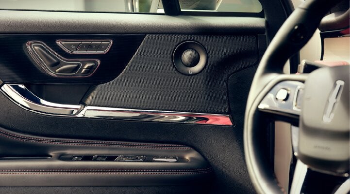 A Revel® audio speaker is shown in the driver's side door of a 2025 Lincoln Corsair® SUV. | Rydell Lincoln in Independence IA