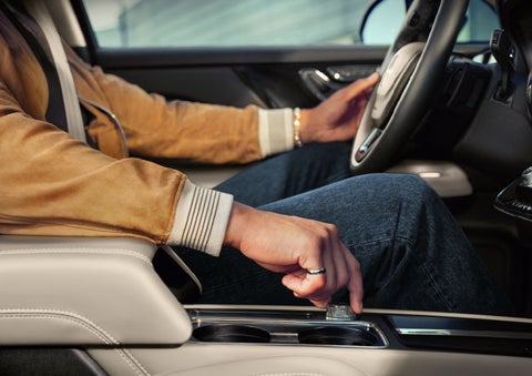 The driver of a 2024 Lincoln Corsair® SUV is shown selecting the drive mode. | Rydell Lincoln in Independence IA