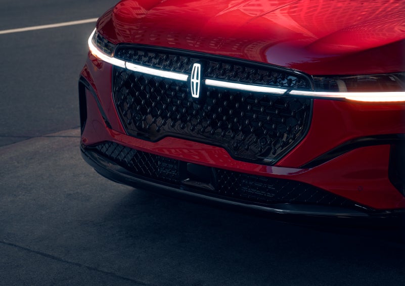 The available front LED light bar and center Lincoln Star logo glow at dusk. | Rydell Lincoln in Independence IA