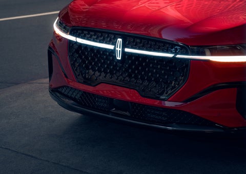 The available front LED light bar and center Lincoln Star logo glow at dusk. | Rydell Lincoln in Independence IA