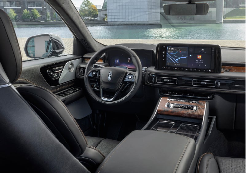The interior of the 2026 Lincoln Aviator® SUV is shown parked with a view of a harbor through the windshield. | Rydell Lincoln in Independence IA