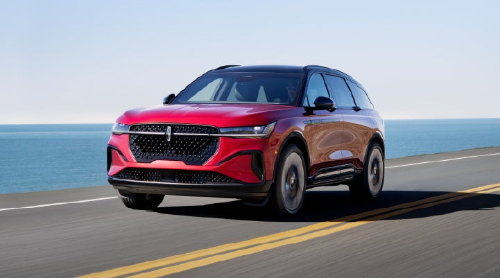 A 2026 Lincoln Nautilus® SUV is being driven on a seaside roadway. | Rydell Lincoln in Independence IA