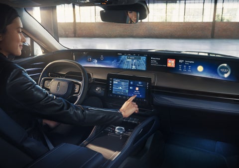 The driver of a 2026 Lincoln Nautilus® SUV interacts with the center touchscreen. | Rydell Lincoln in Independence IA