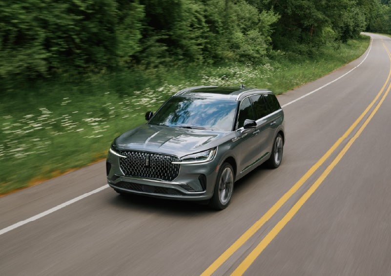 A 2027 Lincoln Aviator® SUV is being driven down a road. | Rydell Lincoln in Independence IA