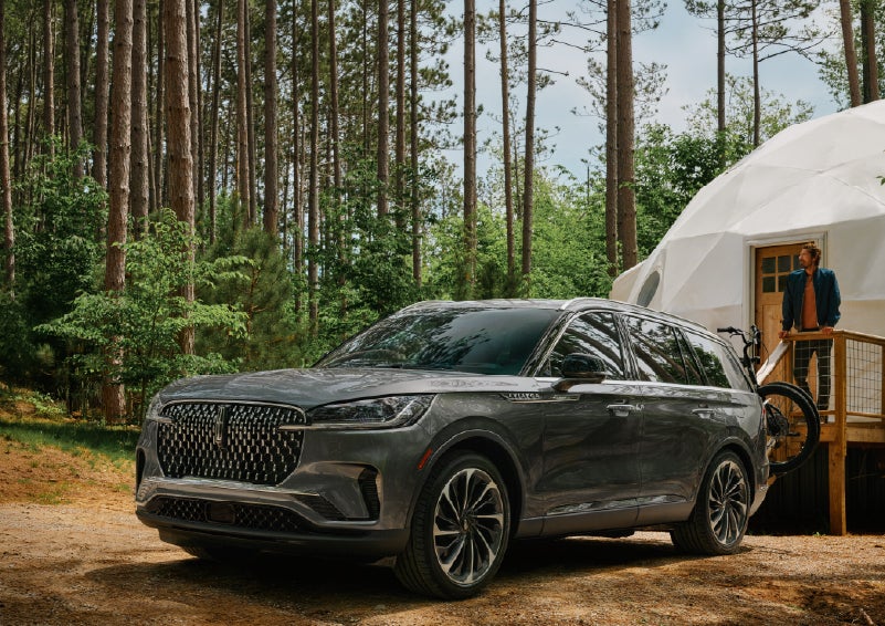 A 2027 Lincoln Aviator® is parked next to a high end glamping site. | Rydell Lincoln in Independence IA