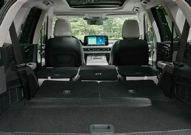 A rear to front view of the interior of a 2027 Lincoln Aviator® Black Label™ SUV shows the third and second rows folded flat | Rydell Lincoln in Independence IA