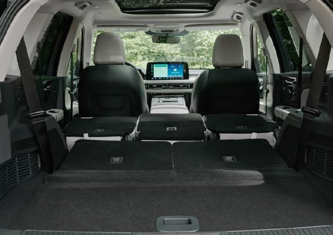 A rear to front view of the interior of a 2027 Lincoln Aviator® Black Label™ SUV shows the third and second rows folded flat | Rydell Lincoln in Independence IA