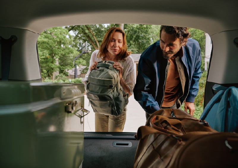 A couple loads luggage into the rear of a 2027 Lincoln Aviator® Black Label™ SUV..e 202 | Rydell Lincoln in Independence IA